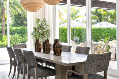 Dining room - large tropical marble floor and white floor dining room idea in Miami with beige walls