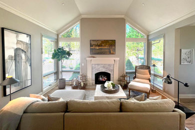 Family room - mid-sized country open concept light wood floor, beige floor and vaulted ceiling family room idea in Other with beige walls, a standard fireplace, a stone fireplace and a wall-mounted tv
