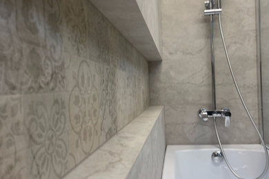 Mid-sized master beige tile and ceramic tile bathroom photo in New York with beige walls, tile countertops, a hinged shower door and a niche