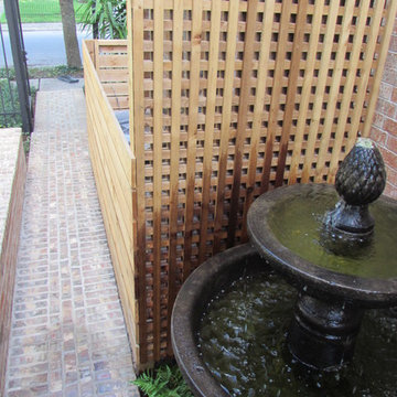 High function in a small side yard! Pergola, raised bed, mirrored wall, fountain