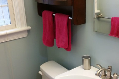 Small transitional master white tile and porcelain tile porcelain tile alcove shower photo in Richmond with shaker cabinets, medium tone wood cabinets, a two-piece toilet, blue walls and a console sink