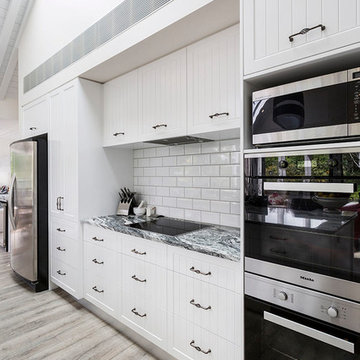 Black and white granite benchtop with white cabinets