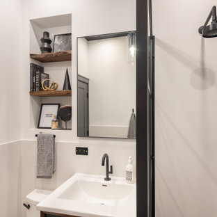 Inspiration for a small modern white tile and porcelain tile porcelain tile, black floor, single-sink, wallpaper ceiling and wainscoting bathroom remodel in Chicago with furniture-like cabinets, brown cabinets, a one-piece toilet, white walls, an integrated sink, solid surface countertops, white countertops, a niche and a freestanding vanity