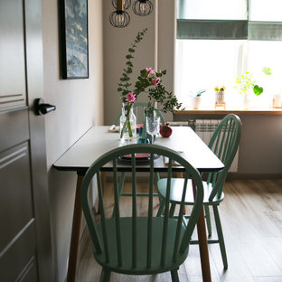 Photo of a small scandinavian single-wall eat-in kitchen in Saint Petersburg with a drop-in sink, flat-panel cabinets, pink cabinets, laminate benchtops, grey splashback, porcelain splashback, black appliances, vinyl floors, no island, beige floor and black benchtop.