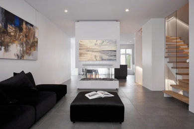 Living room - mid-sized contemporary formal and open concept ceramic tile and gray floor living room idea in Montreal with white walls, a hanging fireplace, a metal fireplace and a wall-mounted tv