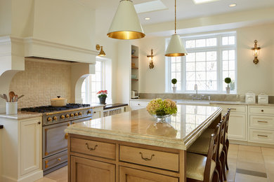 Photo of a country kitchen in Chicago with a farmhouse sink, shaker cabinets, white cabinets, beige splashback, stainless steel appliances and with island.