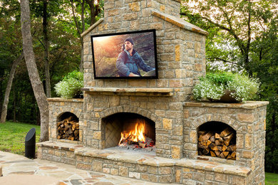 Inspiration for a large transitional backyard patio in Other with a fire feature and natural stone pavers.
