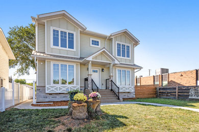 Inspiration for a large contemporary green two-story concrete fiberboard and board and batten house exterior remodel in Edmonton with a mixed material roof and a brown roof