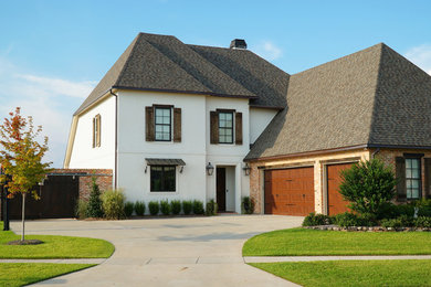 Mountain style white two-story stucco exterior home photo in New Orleans
