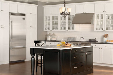 Eat-in kitchen - traditional medium tone wood floor eat-in kitchen idea in Indianapolis with an undermount sink, recessed-panel cabinets, dark wood cabinets, marble countertops, white backsplash, subway tile backsplash and stainless steel appliances