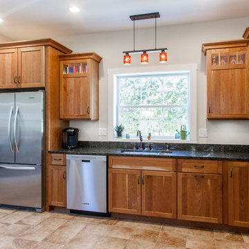 Natural Cherry Shaker kitchen with dark granite countertops