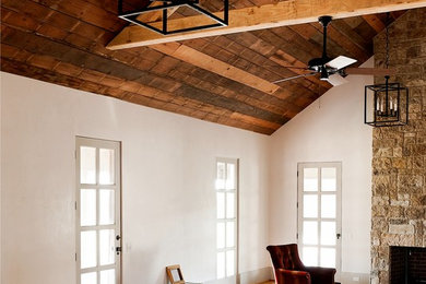 Inspiration for a large rustic open concept medium tone wood floor living room remodel in Houston with white walls, a standard fireplace and a stone fireplace