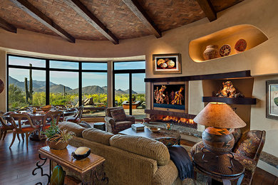Living room - southwestern open concept medium tone wood floor living room idea in Phoenix with a ribbon fireplace