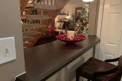Small elegant single-wall dry bar photo in Philadelphia with wood countertops and brown countertops