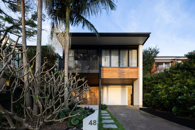 Photo of a large contemporary two-storey house exterior in Sydney with wood siding.