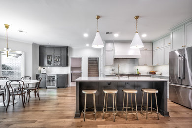 Eat-in kitchen - large medium tone wood floor and brown floor eat-in kitchen idea in Other with an undermount sink, flat-panel cabinets, gray cabinets, quartz countertops, white backsplash, quartz backsplash, stainless steel appliances, an island and white countertops