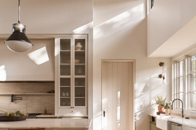 Example of a huge light wood floor and shiplap ceiling open concept kitchen design in Austin with shaker cabinets and an island
