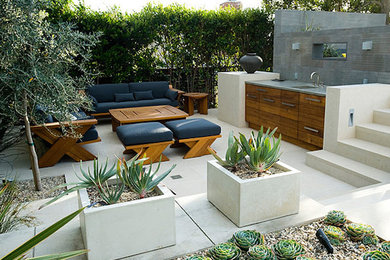Example of a large backyard patio kitchen design in Los Angeles with no cover