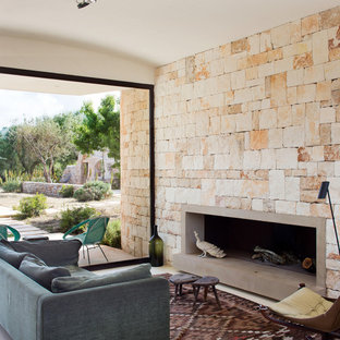 Modelo de salón para visitas mediterráneo, sin televisor, con chimenea lineal y marco de chimenea de hormigón
