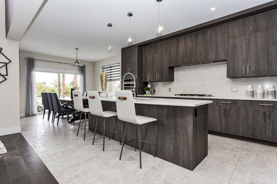 Example of a large minimalist l-shaped eat-in kitchen design in Ottawa with flat-panel cabinets, brown cabinets, laminate countertops, white backsplash, quartz backsplash, stainless steel appliances, an island and white countertops
