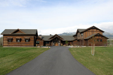 Inspiration for a large rustic brown two-story wood exterior home remodel in Other
