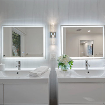 Spa bathroom with dual backlit vanities