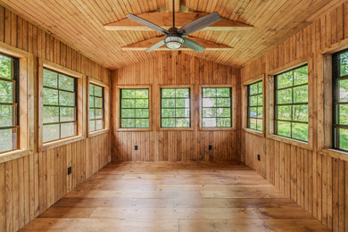 Large mountain style light wood floor and brown floor sunroom photo in DC Metro