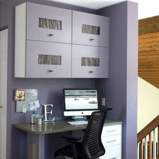 This is an example of a contemporary home office in Denver with purple walls.