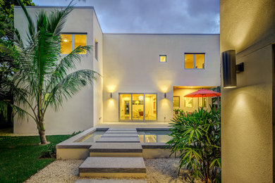 Photo of a mid-sized contemporary partial sun backyard gravel formal garden in Tampa.