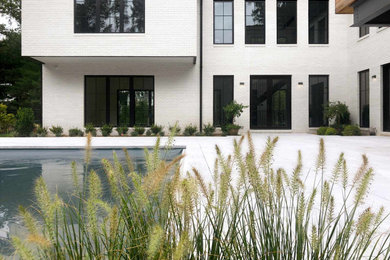 Example of a large country backyard stone and rectangular natural pool design in New York