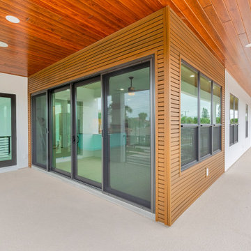 Modern Balcony with Wood Soffit and Sliding Glass Doors