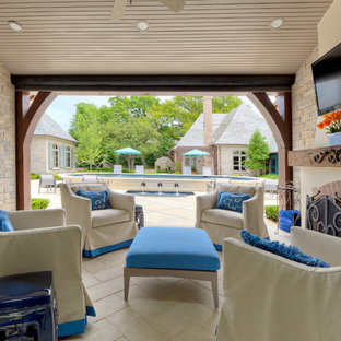 Photo of a traditional patio in Dallas with a fire feature and a roof extension.