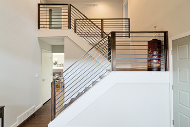 Example of a large minimalist wooden u-shaped mixed material railing staircase design in Other with wooden risers