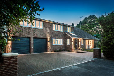 Design ideas for a large and brown contemporary two floor brick detached house in Surrey with a pitched roof, a tiled roof and a brown roof.