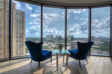 Inspiration for a large contemporary formal and open concept light wood floor and gray floor living room remodel in Houston with no tv, gray walls and no fireplace
