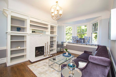 Living room - mid-sized transitional enclosed medium tone wood floor living room idea in San Francisco with gray walls, a standard fireplace and a stone fireplace