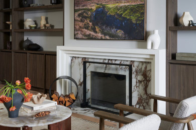 トロントにある高級な広いトランジショナルスタイルのおしゃれなリビング (白い壁、淡色無垢フローリング、標準型暖炉、石材の暖炉まわり、ベージュの床) の写真