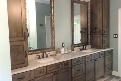 Bathroom - mid-sized transitional master gray tile and porcelain tile porcelain tile bathroom idea in Other with shaker cabinets, distressed cabinets, a two-piece toilet, green walls, an undermount sink and quartz countertops