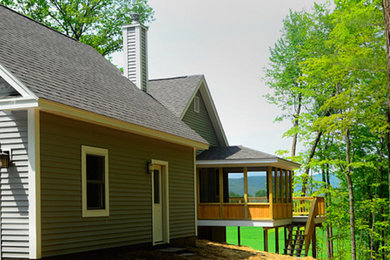 Example of a mid-sized gray one-story wood exterior home design in Burlington with a hip roof