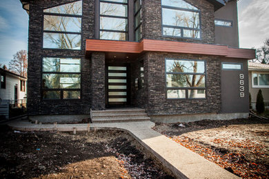 Design ideas for a modern two-storey stucco grey exterior in Edmonton.