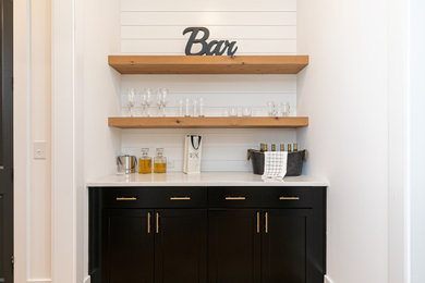 Design ideas for a small country single-wall home bar in Atlanta with no sink, shaker cabinets, black cabinets, white splashback, timber splashback, quartzite benchtops and white benchtop.