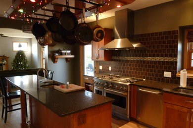 Kitchen pantry - mid-sized contemporary kitchen pantry idea in Jacksonville with recessed-panel cabinets, medium tone wood cabinets and an island