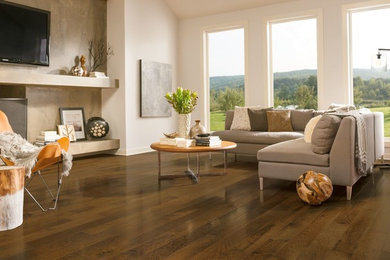Living room - large transitional open concept dark wood floor living room idea in Chicago with white walls, a standard fireplace, a concrete fireplace and a wall-mounted tv