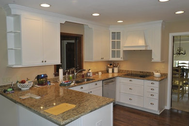 Small arts and crafts u-shaped dark wood floor kitchen photo in Chicago with a double-bowl sink, louvered cabinets, white cabinets, granite countertops and a peninsula