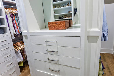 Inspiration for a large timeless gender-neutral medium tone wood floor closet remodel in Jacksonville with flat-panel cabinets and white cabinets
