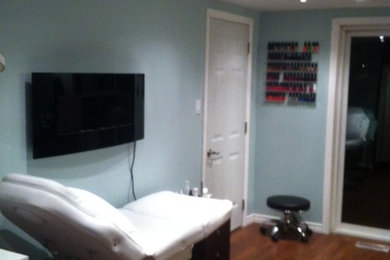 Mid-sized minimalist dark wood floor home studio photo in Ottawa with blue walls