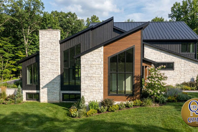 Trendy two-story wood and board and batten house exterior photo in Other with a shed roof, a metal roof and a blue roof