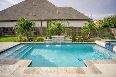 Example of a mid-sized minimalist backyard rectangular pool design in Houston with decking