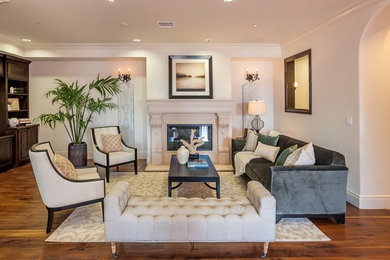 Inspiration for a large transitional formal and enclosed medium tone wood floor living room remodel in Los Angeles with beige walls, a standard fireplace and no tv