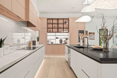 Example of a large trendy u-shaped eat-in kitchen design in San Francisco with an undermount sink, paneled appliances and an island